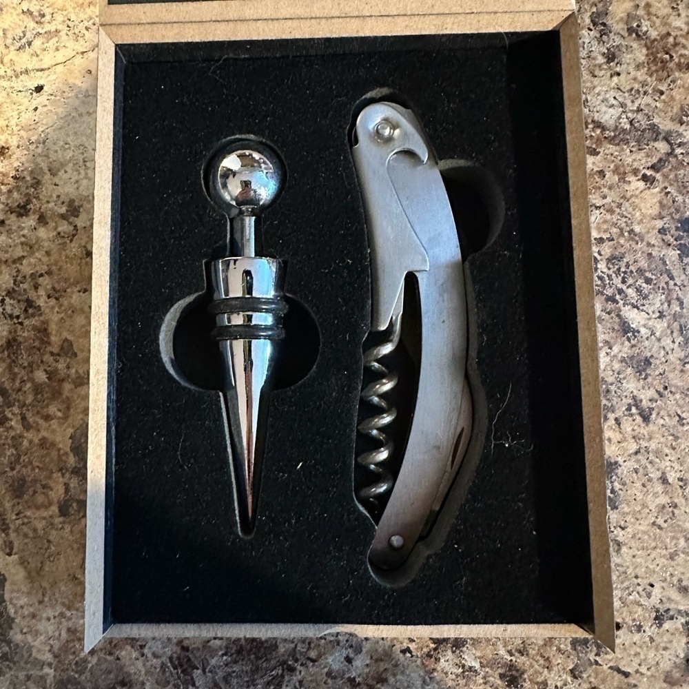 Bottle opener with corkscrew and bottle stopper